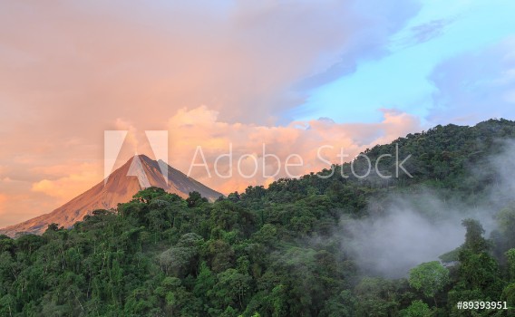 Bild på Sunset by Arenal Volcano in Costa Rica cloud forest clouds rise from the jungle floor